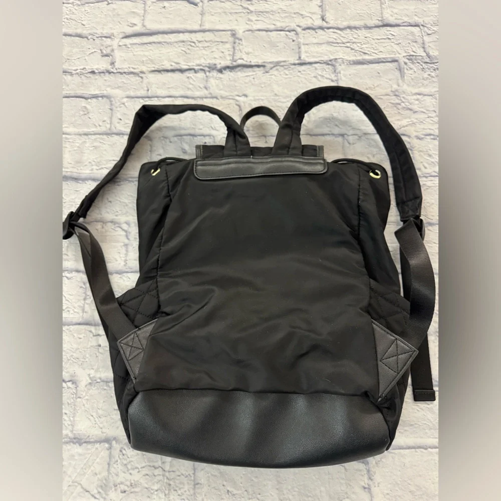 Juicy Couture black quilted backpack heart motif, drawstring top.